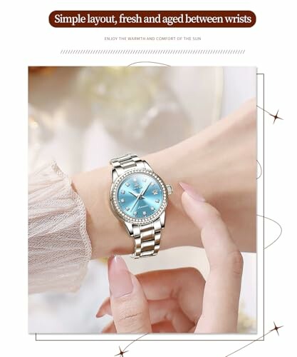 Elegant silver watch with blue dial on wrist.