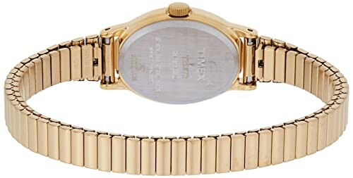 Back view of gold wristwatch with metal band.