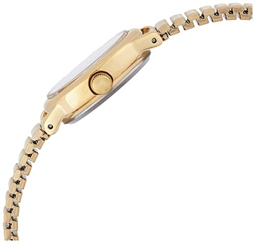Side view of a gold wristwatch with a metal band.