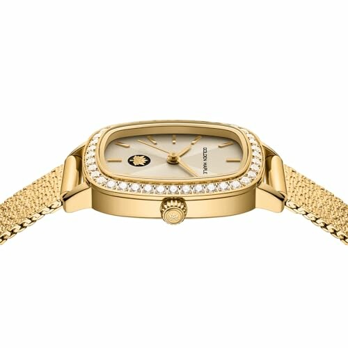 Gold luxury watch with diamond bezel and mesh bracelet.