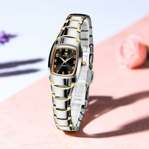 Elegant wristwatch with silver and gold accents on a decorative surface.